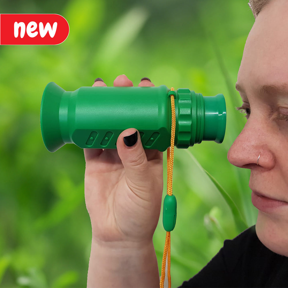 A close-up of the Super Telescope against a backdrop of lush greenery. The telescope features adjustable focus and offers powerful magnification for observing intricate details in nature. Perfect for nature enthusiasts and educational programs, it allows 