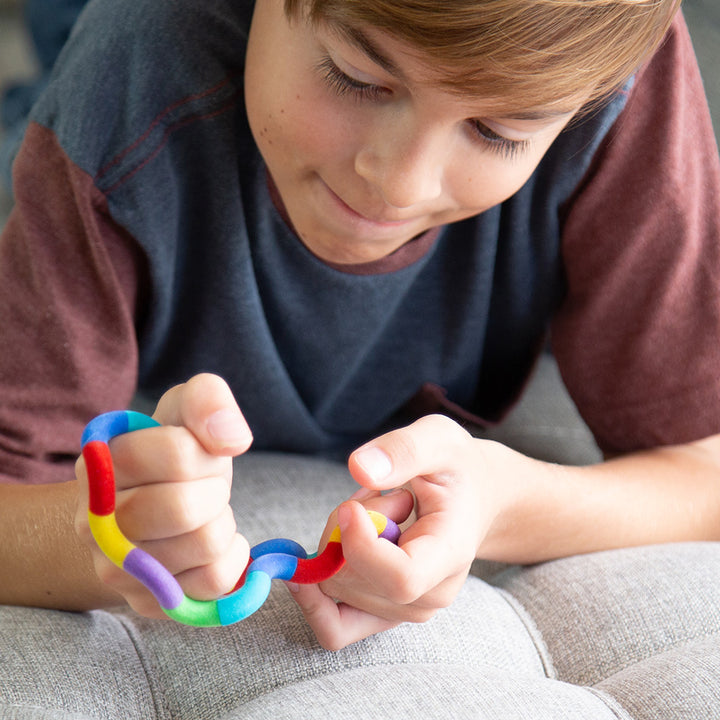 Tangles - a tactile toy consisting of interconnected curved sections, designed to provide both visual and tactile stimulation. Widely used as a fidget toy, it offers a satisfying sensory experience, promoting relaxation and focus. Its flexible structure a