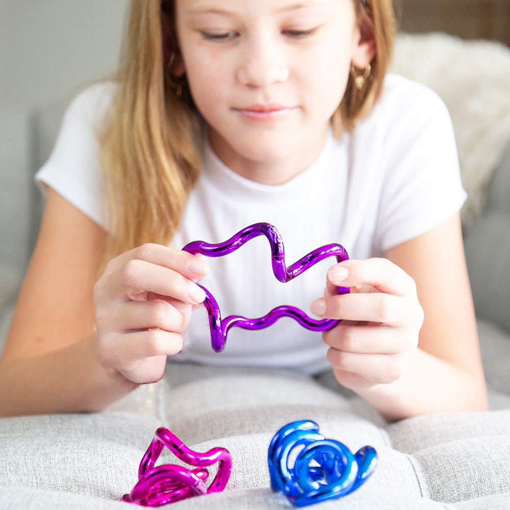 Tangles - a tactile toy consisting of interconnected curved sections, designed to provide both visual and tactile stimulation. Widely used as a fidget toy, it offers a satisfying sensory experience, promoting relaxation and focus. Its flexible structure a