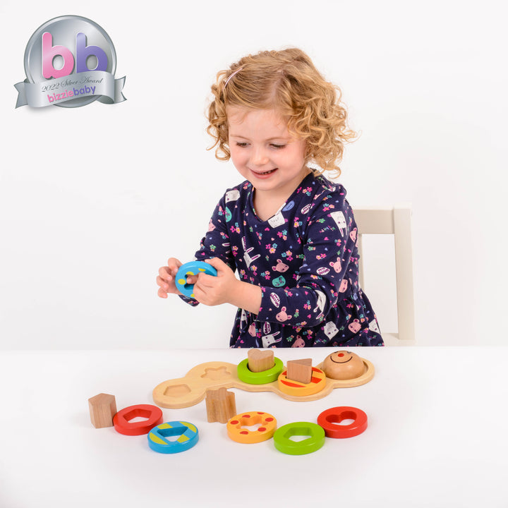 Children love to play with this endearing wooden Wiggly Worm. It contains 4 removable shape rods and 12 shape pieces for stacking, counting, and shape recognition