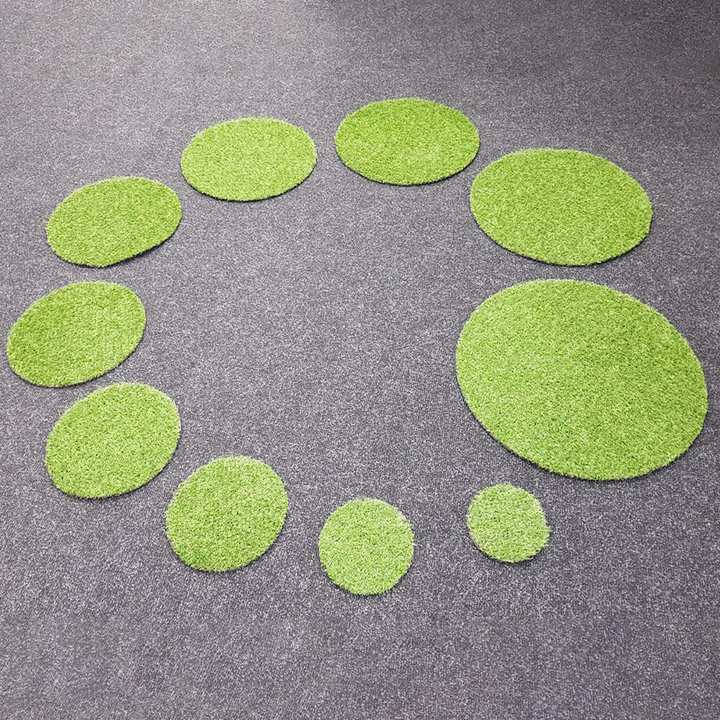 Artificial, durable grass shapes suitable for indoor or outdoor use. Children can enjoy the sensorial experience while learning about shape, counting, and size. Sizes range from approximately 15 cm to 60 cm in diameter.