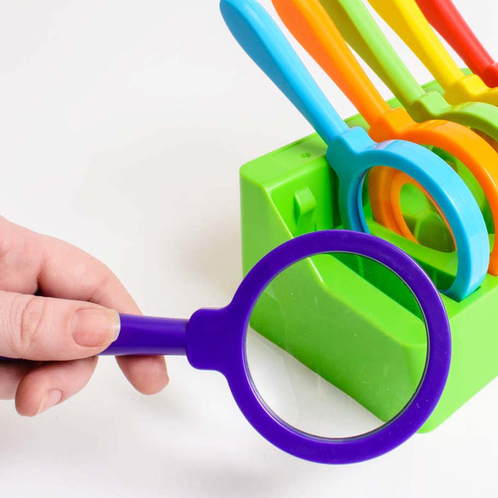 Set of six brightly colored, extra-large hand-held magnifying glasses with 3x magnification. Includes a convenient stand for safe storage when not in use. Perfectly sized for small hands, ideal for exploring plants, animals, and insects in life science le